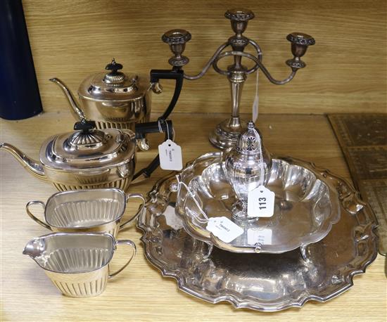 A four-piece plated tea service and a plated tray, candelabrum, swing-handled basket and caster
